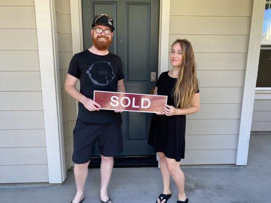 Us in front of our first home. Thanks Rob!