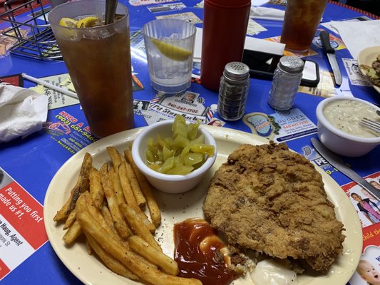 Chicken fried chicken, seasoned fries and pickled tomatoes.