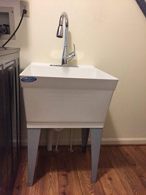 Laundry tub with a pull down kitchen faucet