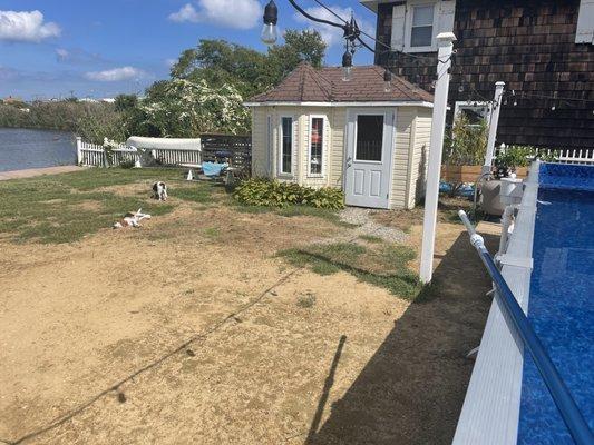 My dirt yard, one of three solar panels sitting not connected and the pool that is thankfully standing.