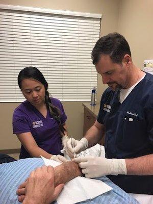 Provider and assistant taking care of patient