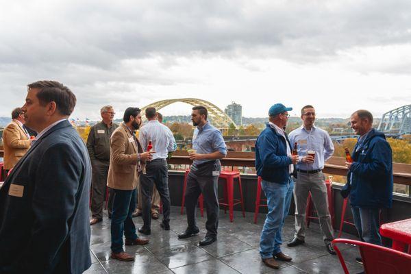 Employees and guests enjoying drinks on our patio overlooking the Ohio River.