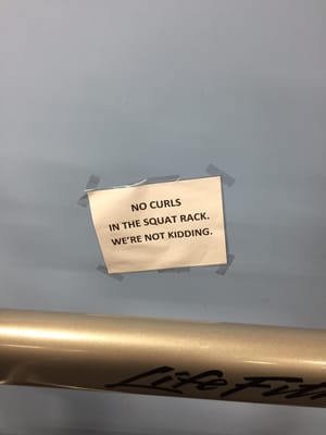 Warning by the squat rack.