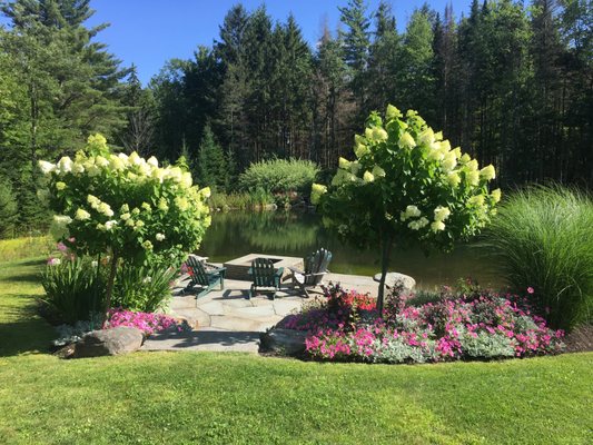 Flowers and a pond with outdoor chairs