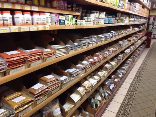 Rows of spices & herbs, rices, lentils, etc.