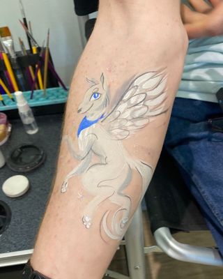 Custom arm painting of a winged wolf done at a corporate event in Pearland, Texas.