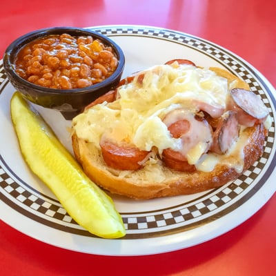 Kielbasa Reuben - Slices of grilled rye bread piled high with Kielbasa medallions, sauerkraut, Swiss cheese and Russian dressing