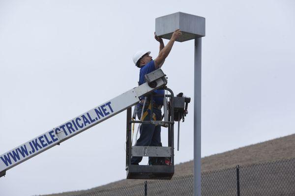 We have a bucket truck to reach the tall pole lights!