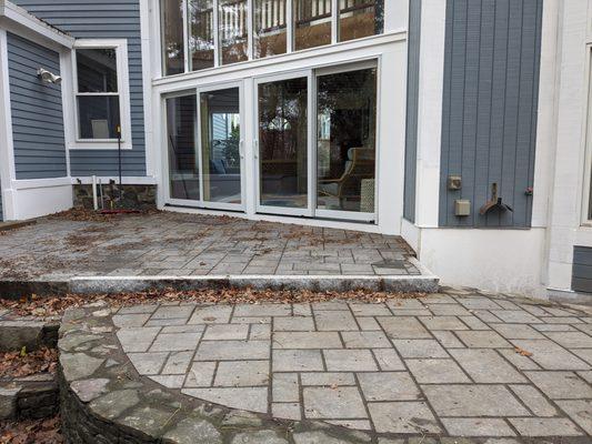 Patio doors replaced with sliding doors and patio completely repaved.