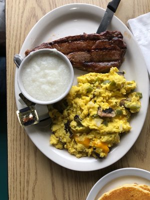 New York Strip, grits, and eggs w/shrooms, onions, pepper, cheddar.