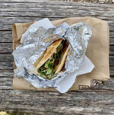 Mushroom with onions, goat cheese, greens and hot sauce in a pita.