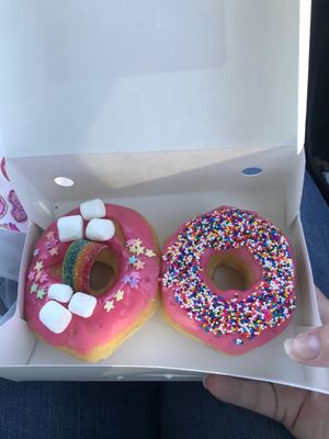 A Fancy donut and a strawberry sprinkle