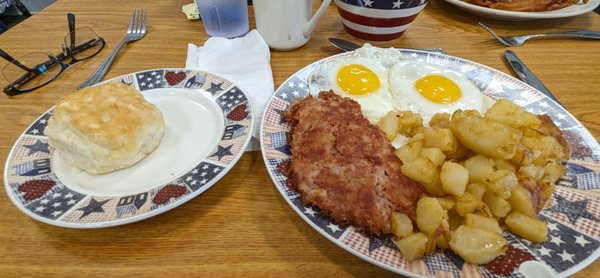 Two eggs with corned beef hash, comes with biscuit and home fries.