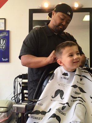 Excellent barber, w/ patience for leery kids!