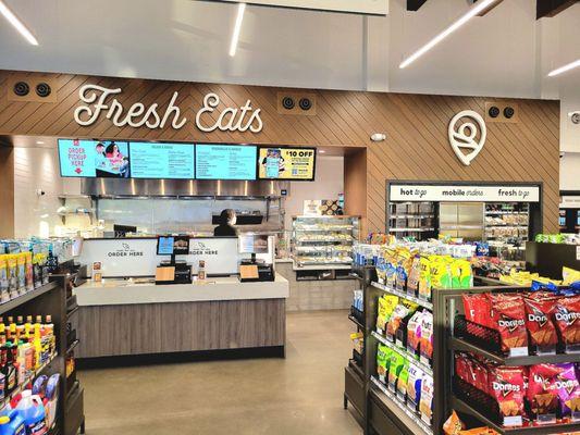 The order kiosks and kitchen. Ready-made food is on the far right.