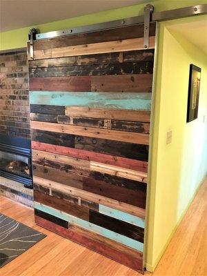 sliding barn door reclaimed material from clients old deck.
 installation with Yellow Moon Construction