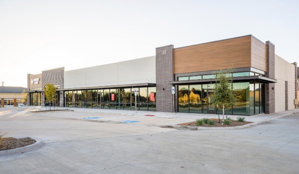 Exterior photo of AFC Urgent Care Allen and it's parking lot.