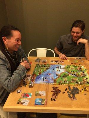 Gather and game staffers playing a staff favorite, Raiders of the North Sea.