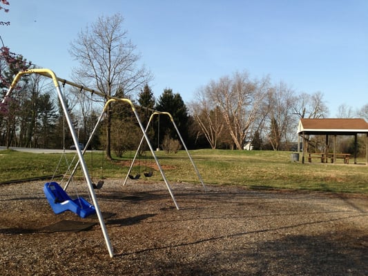 Swings and pavilion in background