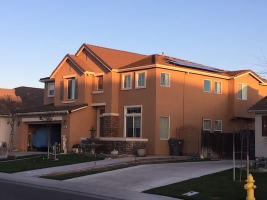 Suburban home, with panels neatly tucked to the side.