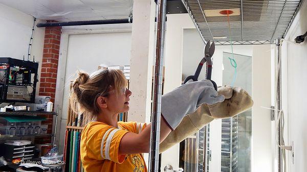 Woman working with molten glass from the Vitrigraph kiln