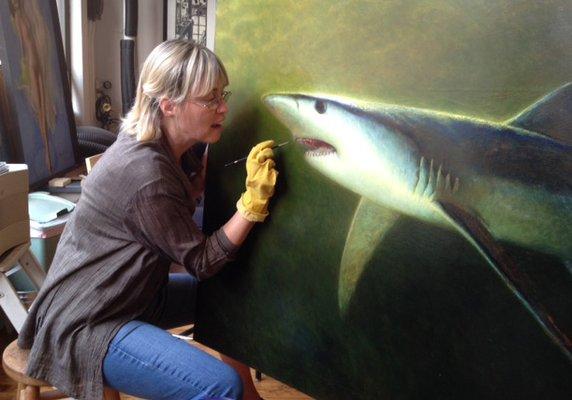 Jill Pratzon facing down Jamie Wyeth's shark before gently restoring it.