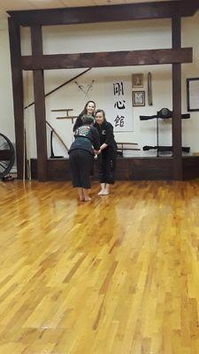 Sempai Luttrell being congratulated by her Sensei after passing her brown belt test