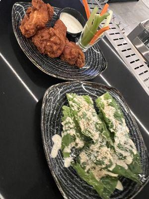 Buffalo chicken wings and reimagined Caesar salad