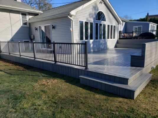 TimberTech Deck Boards With Aluminum Railings and Partial Bench Seating.