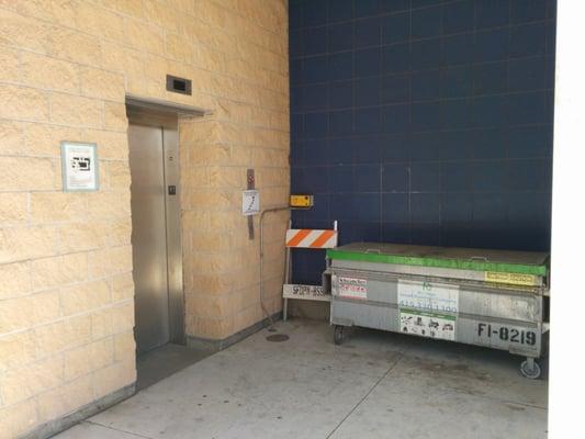 Elevator next to garbage... Ick.