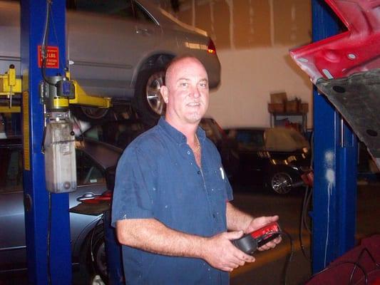 Capt Randy checking a catalytic converter with a scanner.