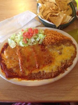 Three enchiladas with cheese, side of beans, rice, and salad.