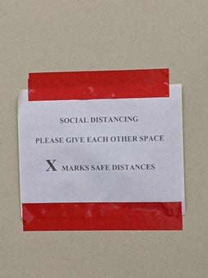 Social distancing is being enforced, but the signage is rather inconspicuous