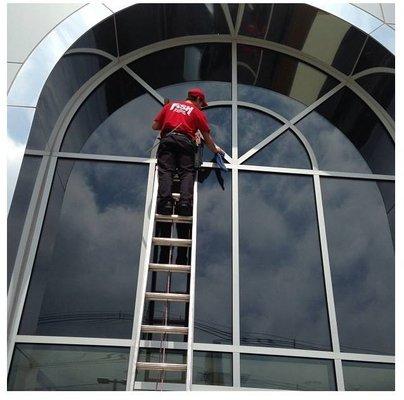 Commercial window cleaning at a car dealership.