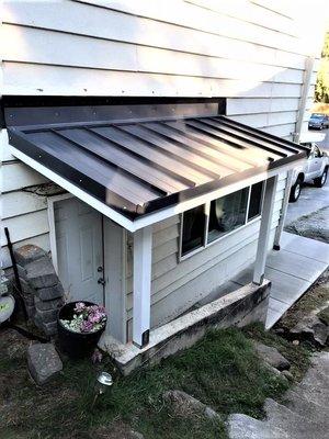 side porch cover and poured concrete walkway.
 installation with Yellow Moon Construction