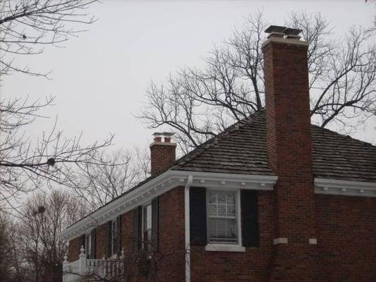 Poured two 6 in. thick chimney crowns and installed chimney caps on both chimneys.