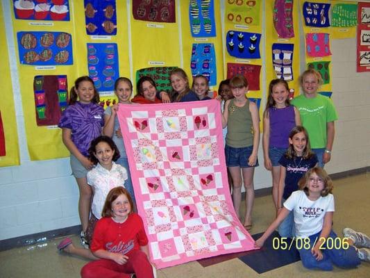 Girl Scout troop makes quilt for Project Night Night for their community service project.