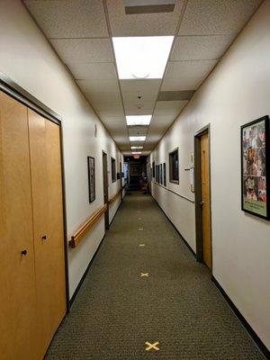 Hallway marked with spots for socially distanced lines