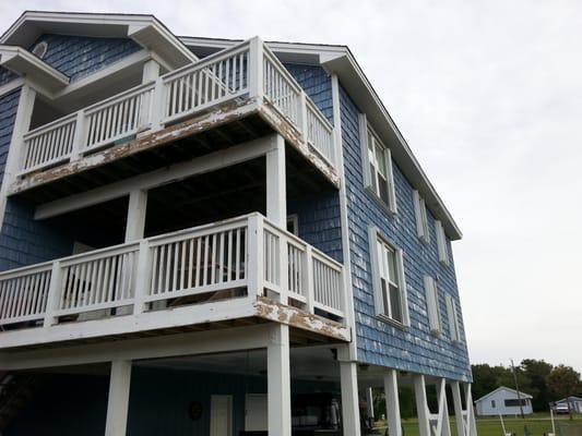 Vinyl siding and wooden railings & beams after a powerwash we will apply 2 coats of Sherwin Williams Duration.Great solid finish