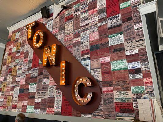 Dr. Coburn's Tonic restaurant feature wall of old drugstore ads with pub style lighting throughout and also a ski area theme