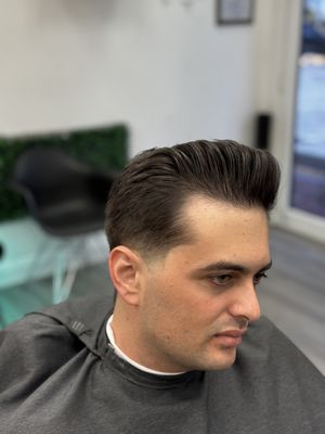 Light tapered pompadour with a slight touch of pomade