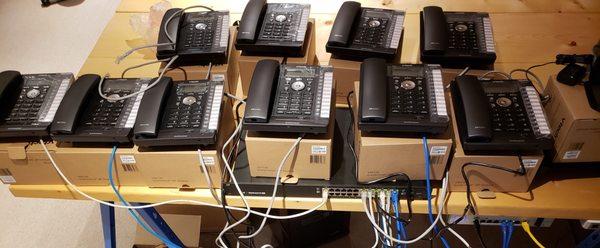 We are working on a new phone system for a customer. This is just a small number of the phones being programmed for install!