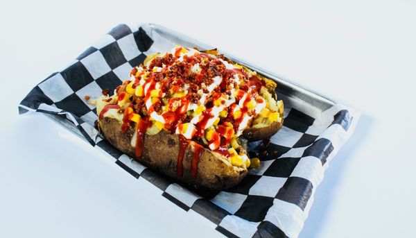 Spud Racer - Loaded potato made with house made Birria & Elote. Topped with bacon bits.