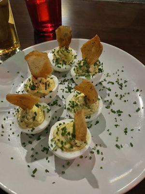 Deviled eggs with dill pickle chip