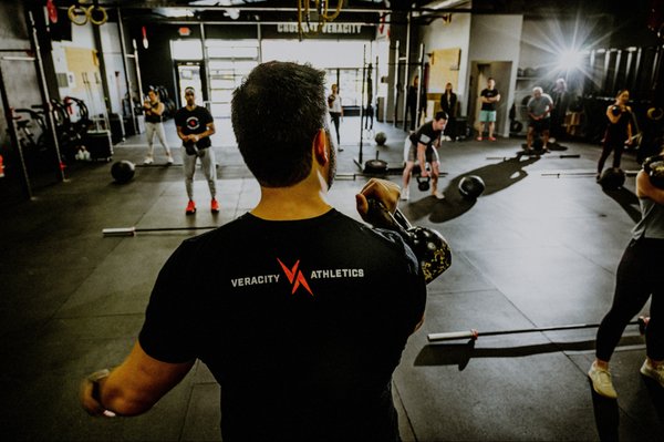 Coach leading a CrossFit group class