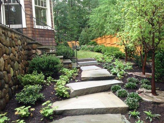 A natural stepping stone path along a side yard