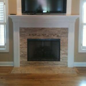 A simple facelift  can disguise the age of a home. Tavertine stacked stone, mosaic inlay mantel, and running bond pattern floor.