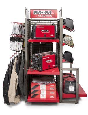 Assortment of Lincoln Electric welding machines, welding helmets, welding MIG guns and gloves and jackets sold by Greco Gas.