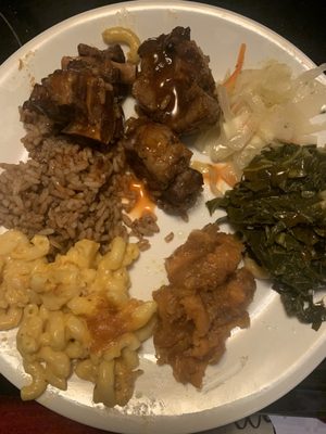 Oxtails, rice, cabbage, greens, candied yams and Mac and cheese