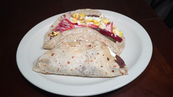 baleadas 
folded flour tortillas filled with beans cream and dried hard cheese crumbs